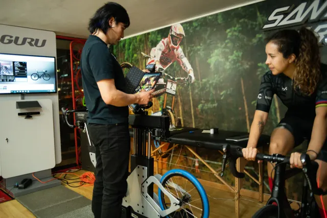 Edwin Castiblanco, ONE scientific director, reviewing a rider’s session on a tablet at the fit simulator